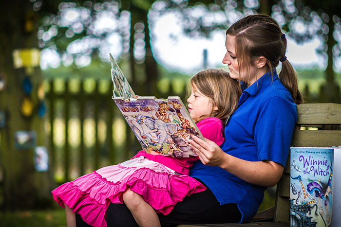 Upper preschoolkey worker teaching reading skills on a 1 to 1 basis